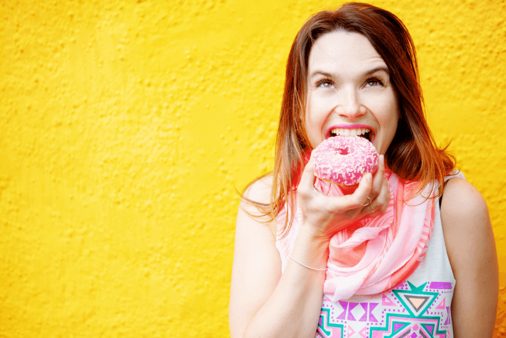 photo of woman overeating a donut