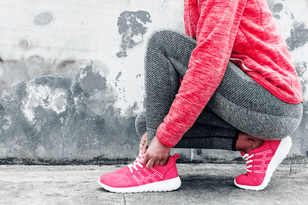 woman tying her shoes preparing to exercise