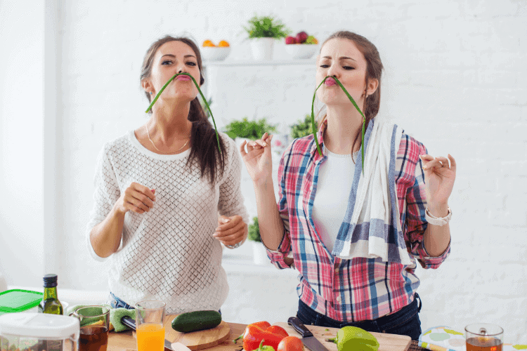 two women enjoying making a healthy meal