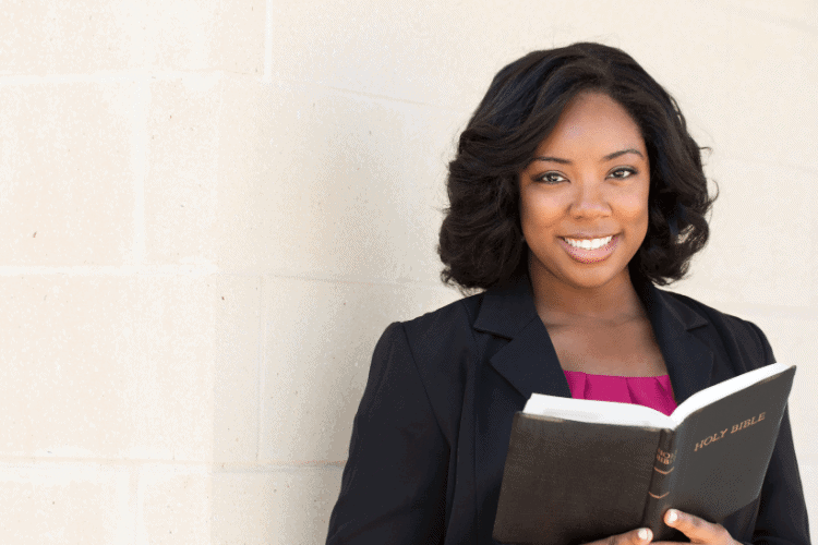 smiling woman reading a Bible
