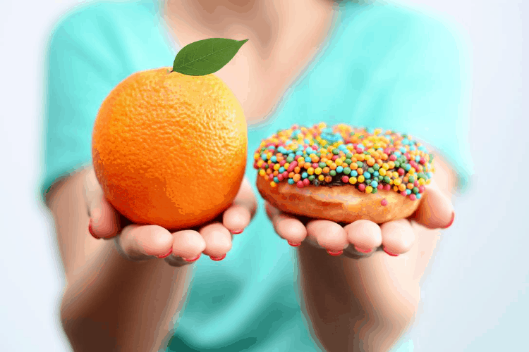 woman choosing between fruit and a donut