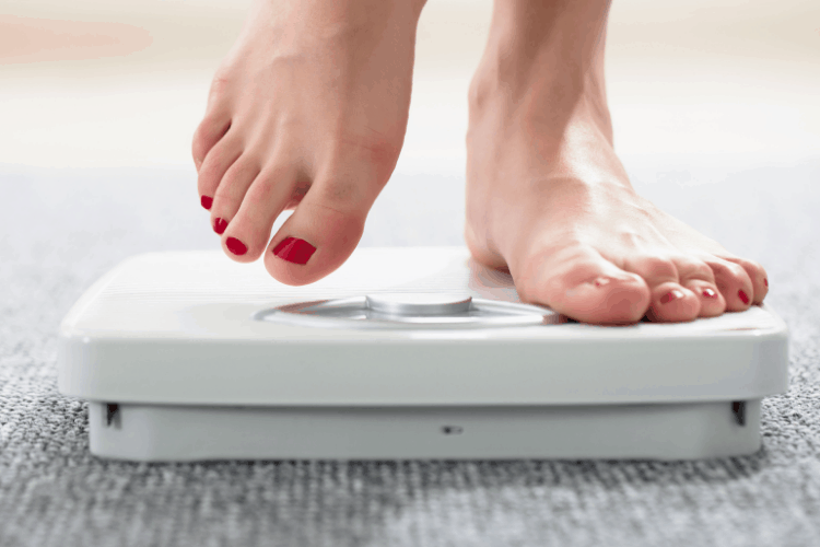woman stepping onto a scale