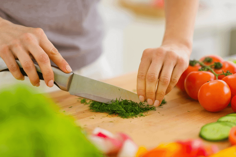 woman chopping herbs for healthy cooking