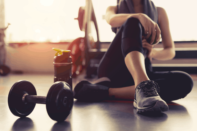 woman with workout equipment and water bottle