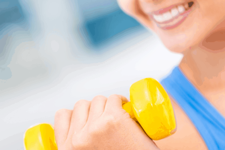 smiling woman with dumbbell 