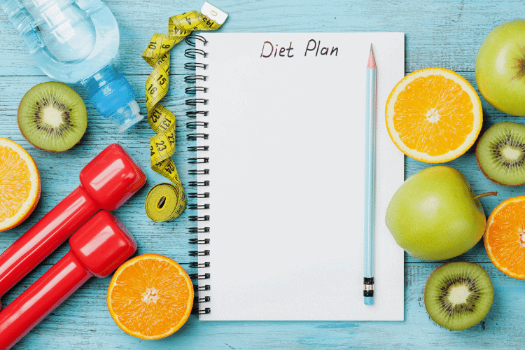 diet plan with pencil, fruit and dumbbells 