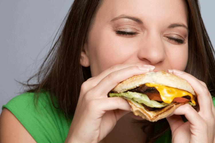 woman eating a cheeseburger