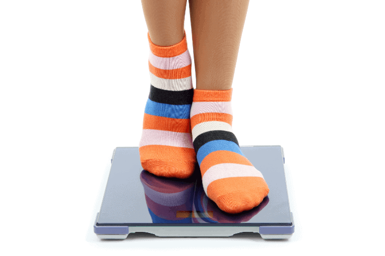 image of feet wearing socks and standing on a scale