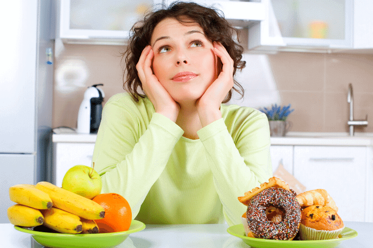 woman choosing fruit or a donut
