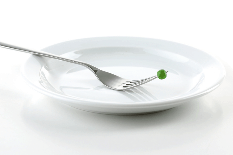 empty plate with fork and pea