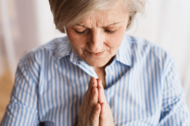 lady praying with hands folded