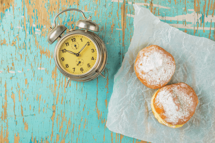 pastries on a table with a clock