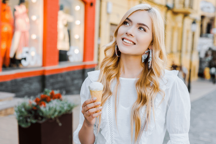 smiling woman eating ice cream