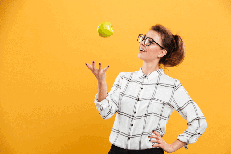 woman tossing apple into the air