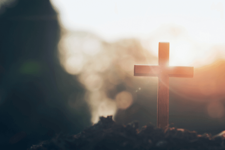 cross with sunrise behind