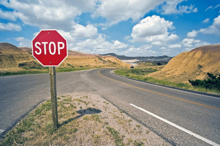 image of stop sign at a crossroad