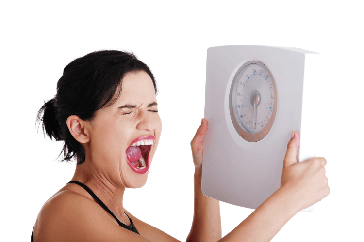 woman holding scale and screaming in frustration