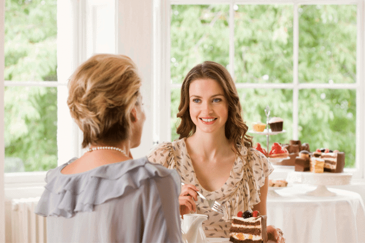 two women sharing cake